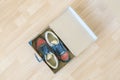 pair of brand new shoes in shoe cartoon box on wooden floor f Royalty Free Stock Photo