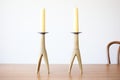 pair of brass candlestick holders with beeswax tapers