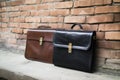 a pair of briefcases leaning against a wall