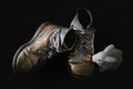 Pair of bronzed baby shoes on black background.