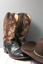 Pair of brown and black cowboy boots with felt cowboy hat Royalty Free Stock Photo