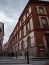 Pair of brown brick buildings standing side by side in a bustling urban street.
