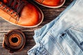 Pair of brown leather male shoes blue jeans and belt dark wooden background, top view closeup Royalty Free Stock Photo