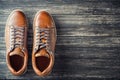 Brown leather men`s boots on wooden background top view with copy space Royalty Free Stock Photo