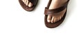 Pair of brown sandals with a brown strap Royalty Free Stock Photo