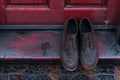 Brown Shoes Resting on Red Door. Generative AI