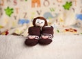 Pair of brown toddler shoes with cute monkeys on it