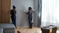 Pair of builders measuring grey wall in appartment Royalty Free Stock Photo