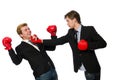 Pair of businessmen boxing on white