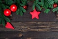 pair of candles and fir branches on wooden boards, space for congratulations in the center Christmas