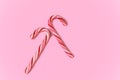 Pair of candy canes on pink background