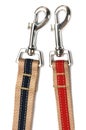 A pair of canvas belts snap clasp hook trigger clips white backdrop Royalty Free Stock Photo