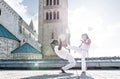 Pair of capoeira performers doing a kicking