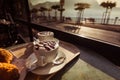 Pair of cappuccino mugs on a table, with blurred lakefront in the background Royalty Free Stock Photo