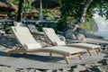 A pair of chairs summer tropical beach lapis ocean shore white sand vacation sunbathing island nature holiday clear sky Royalty Free Stock Photo