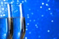 Pair of a champagne flutes on blue light bokeh background Royalty Free Stock Photo