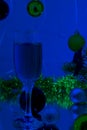 Pair of champagne flutes with gold bubbles make cheers on blue tint light bokeh background Royalty Free Stock Photo