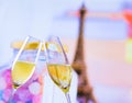 A pair of champagne flutes with golden bubbles on blur tower Eiffel background Royalty Free Stock Photo