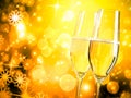 A pair of champagne flutes with golden bubbles on golden light background Royalty Free Stock Photo