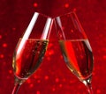 Pair of a champagne flutes on red light bokeh background Royalty Free Stock Photo