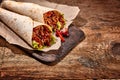 Pair of Chili Stuffed Tex Mex Wraps on Wood Table