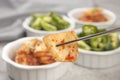 Pair of chopsticks holding kimchi Royalty Free Stock Photo