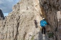 Pair of climbers walking on narrow ledge.