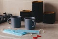 A pair of coffee cups sitting on the table, cogni next two medicinskie masks and confetti of hearts red. A way of life, a new Royalty Free Stock Photo