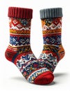 Pair of Colorful Knitted Socks with Geometric Patterns on White Background Royalty Free Stock Photo