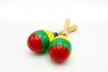 A pair of colorful maracas lying on a white underground Royalty Free Stock Photo