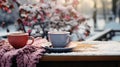 A pair of colorful mittens, a steaming cup of hot cocoa, and a snow-covered park bench, capturing the essence of winter coziness. Royalty Free Stock Photo