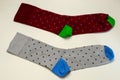 Pair of colorful socks of different colors, lie on white surface. Not isolate