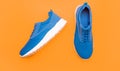 pair of comfortable blue sport shoes on yellow background, footgear