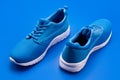 pair of comfortable sport shoes. sporty blue sneakers. shoes on blue background. Royalty Free Stock Photo