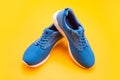 pair of comfortable sport shoes. sporty blue sneakers. shoes on yellow background. Royalty Free Stock Photo