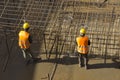 Construction workers attaching rebar