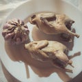 Pair of cooked quails lie on a plate as an example of a healthy diet Royalty Free Stock Photo