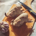 Pair of cooked quails lie on a wooden cutting board as an example of healthy eating Royalty Free Stock Photo