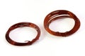 A pair of copper wire coils for use in soldering works white backdrop