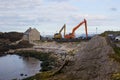 A pair of cranes used to dredge the small harbor at Ballintoy on the North Antrim Coast of Northern Ireland on a calm spring day.