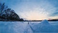 Pair of cross-country skis, snowdrifts, track in snowy winter countryside, low angle view Royalty Free Stock Photo