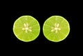 Pair of cross section fresh limes on black background