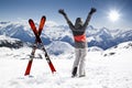 Pair of cross skis with woman skier, hands up