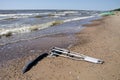 Pair crutches on beach sand near sea