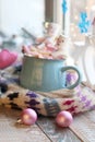 A pair of cups with a drink decorated with meringues and marshmallow snowmen, Christmas decor, hearts, a knitted scarf on the wind