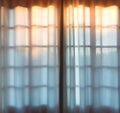 a pair of curtains in front of a window with some white sheets Royalty Free Stock Photo