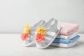 Pair of cute baby sandals and stack of clothes