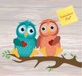 A pair of cute owlet sitting on a branch. Yellow sheet of paper Royalty Free Stock Photo