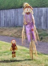 Pair of cute scarecrows on front garden lawn Royalty Free Stock Photo