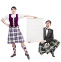 Pair of dancers of Scottish dance with empty banner Royalty Free Stock Photo